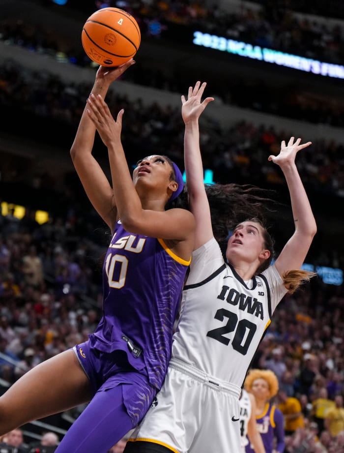 LSU forward Angel Reese drives to the basket to shoot while against Iowa guard Kate Martin during the women's NCAA championship.
